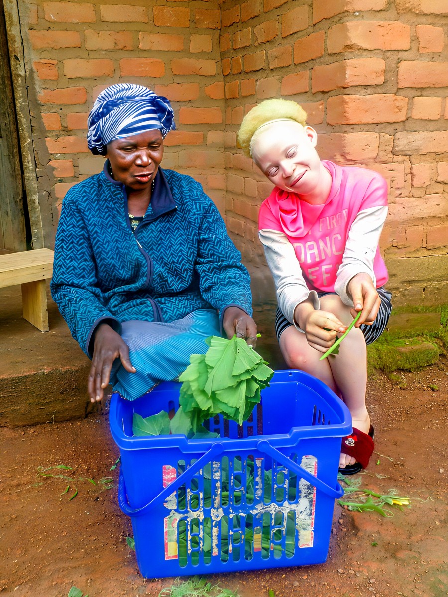 Cleo sits with her beloved grandmother in Zambia