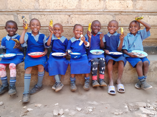 Grade 3 pupils enjoying a nutritious hot meal and a fruit.