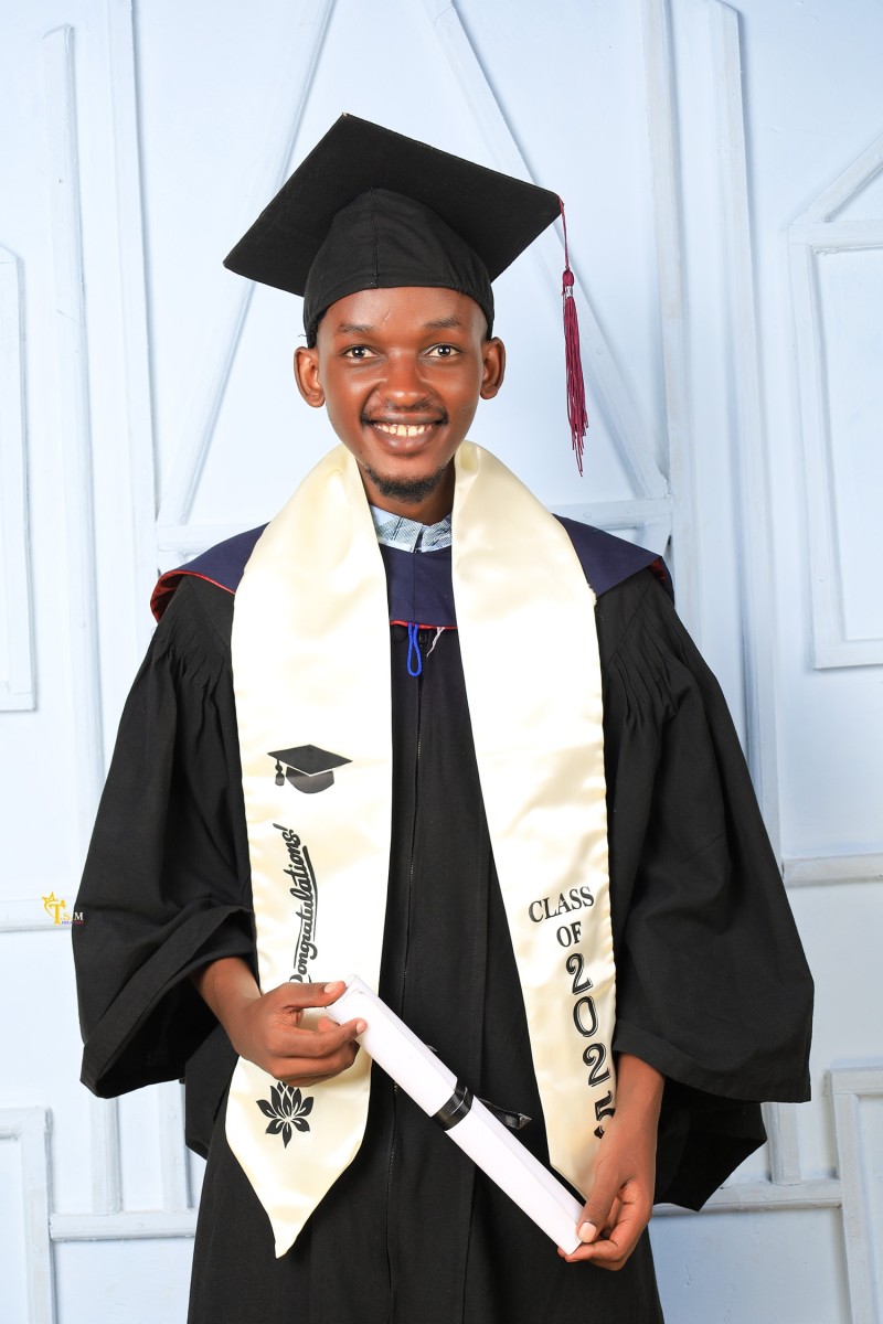 A graduated child in Kenya holding his degree