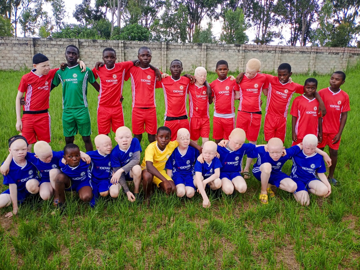 Kawambwa-sports-St.-Marys-team-smile-group-jersies