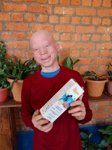 child happy in Zambia to receive his bottle of sunscreen