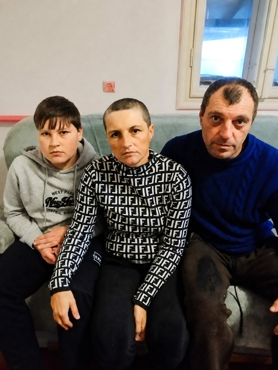 A family in Ukraine seating on sofa