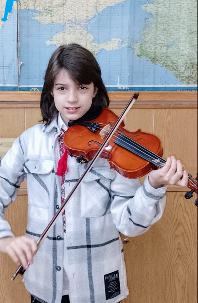 A child in Ukraine playing violin